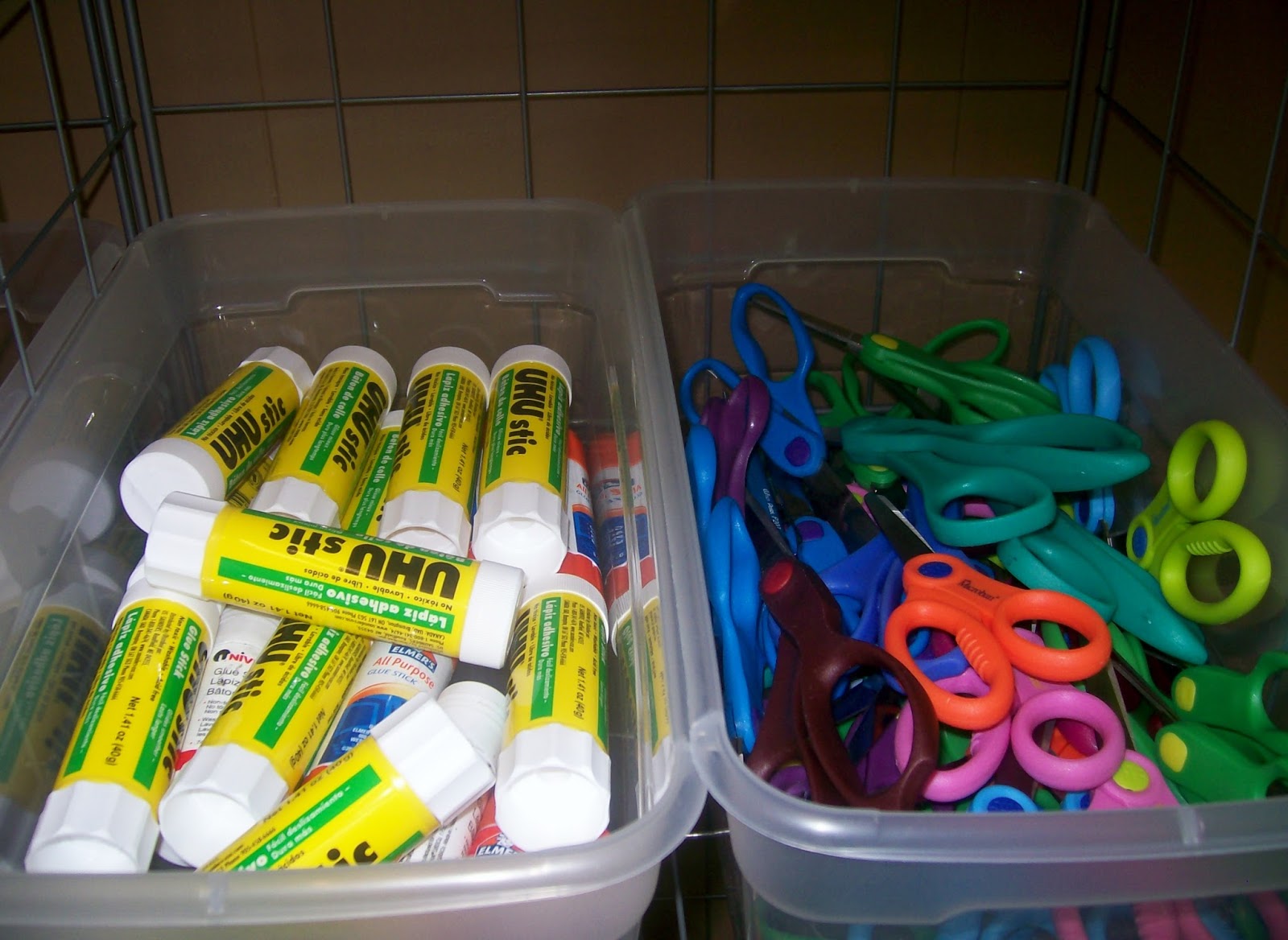 glue sticks and scissors in tubs. 