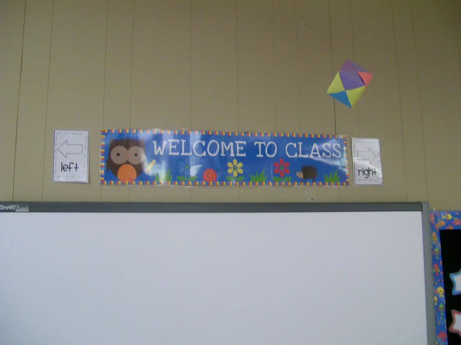 welcome to class poster and left/right signs hanging above smartboard in high school math classroom. 