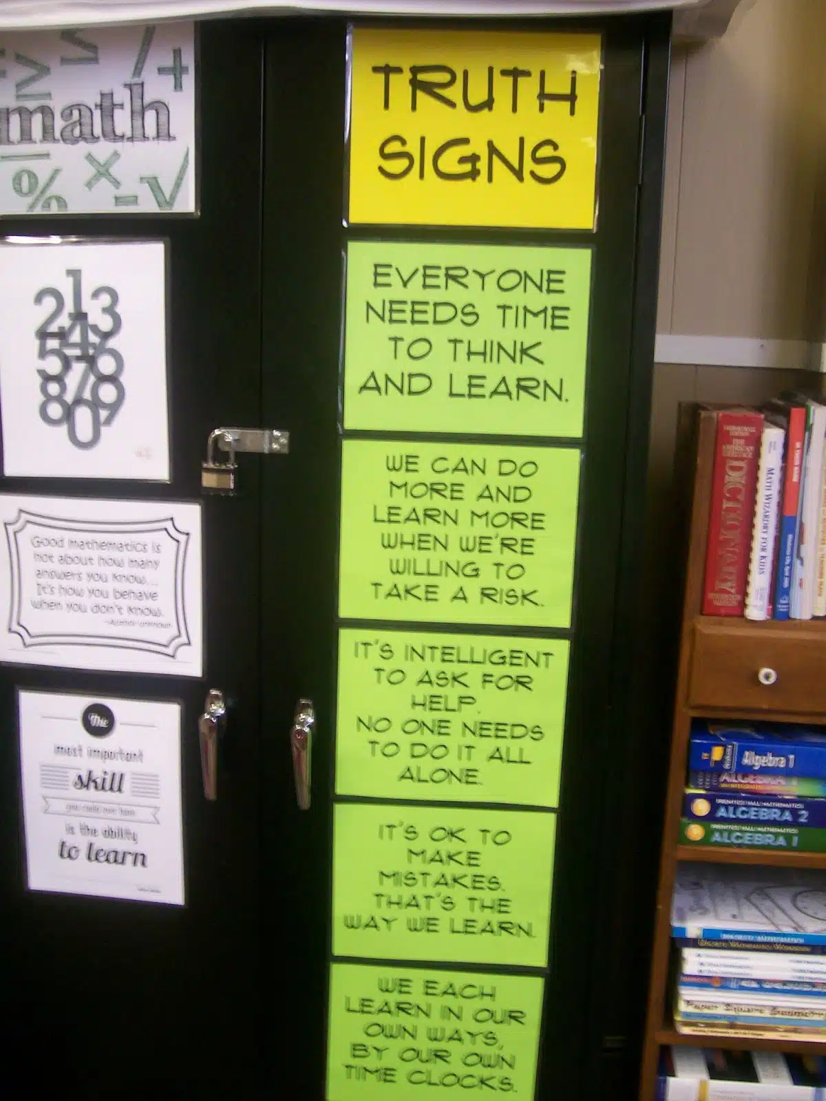 truth signs posters on cabinet in high school math classroom. 