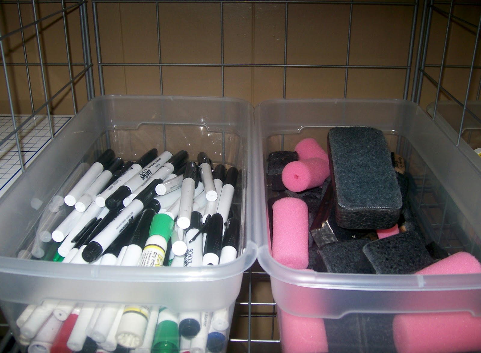 dry erase markers and erasers in tubs. 