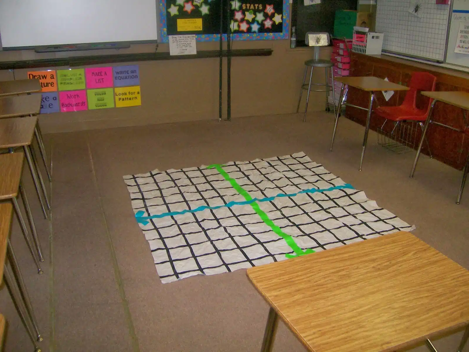 shower curtain coordinate plane in floor of classroom. 