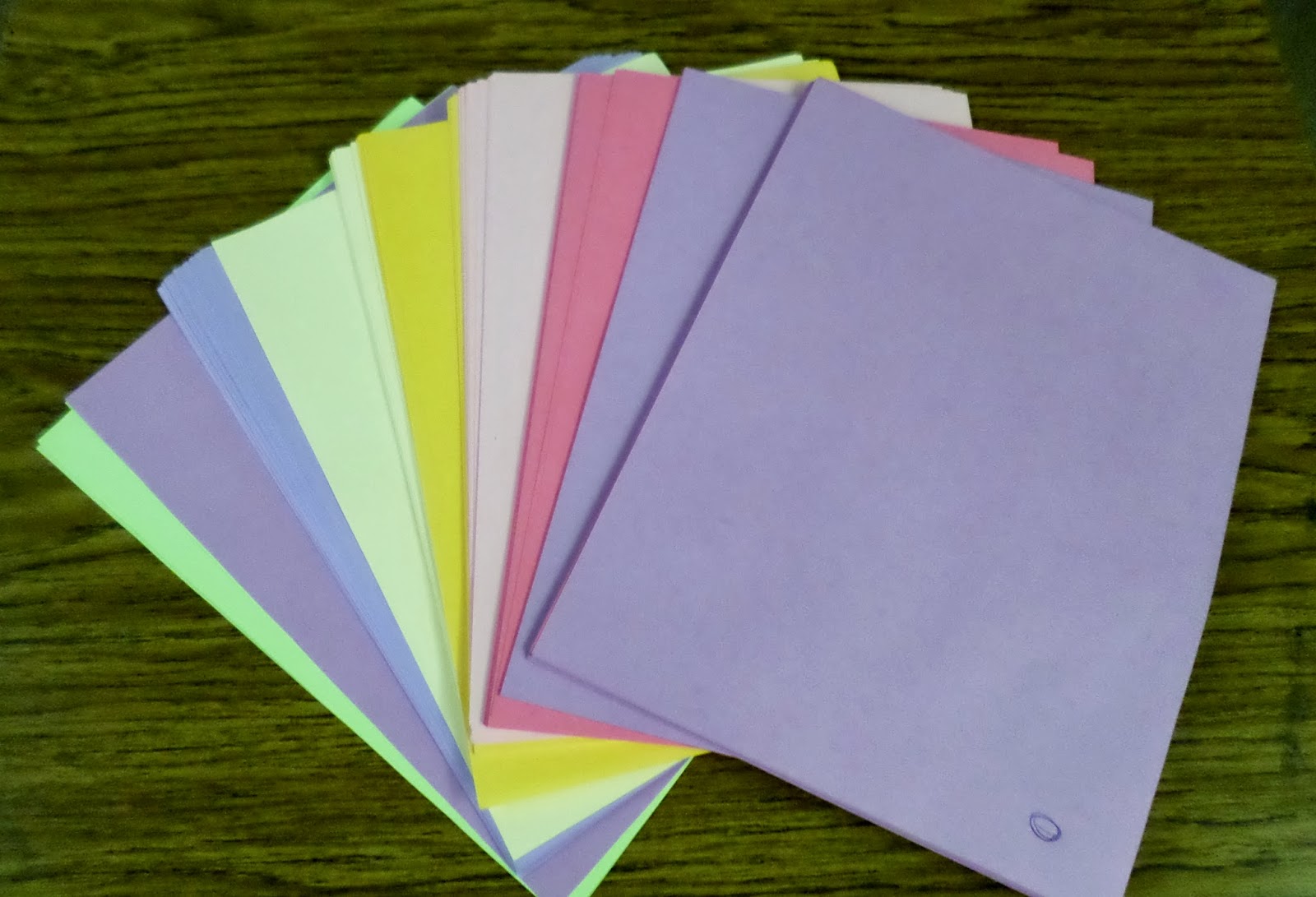 colored paper laying on desk in classroom. 