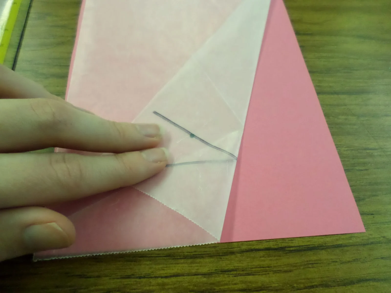 demonstration of repeated folding of wax paper for wax paper parabola activity. 