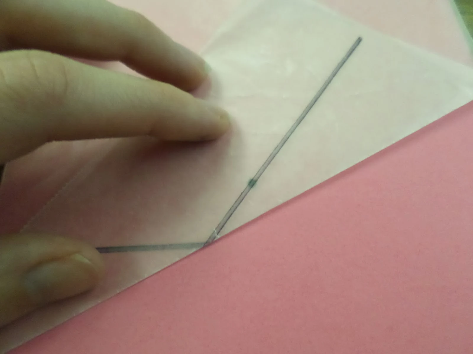 demonstration of folding wax paper in wax paper parabola activity. 