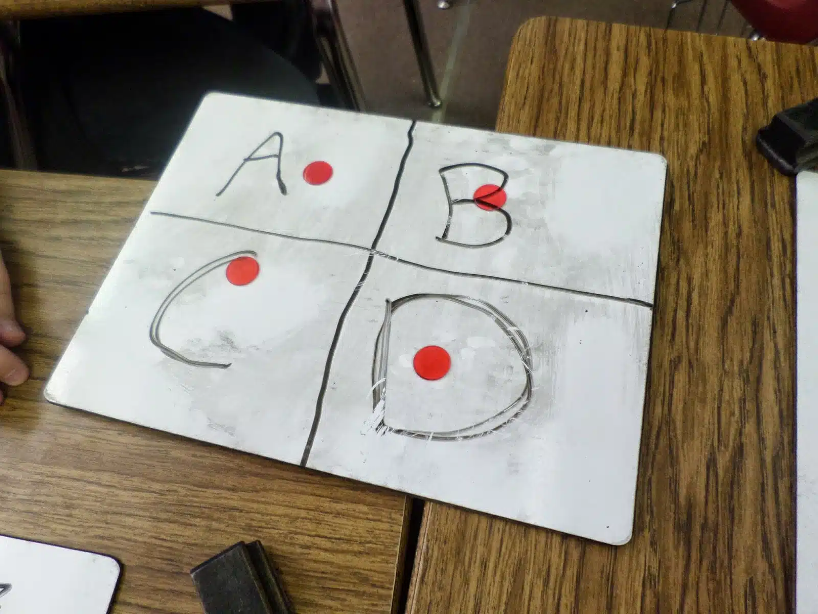 dry erase board with one bingo chip in each quadrant. 