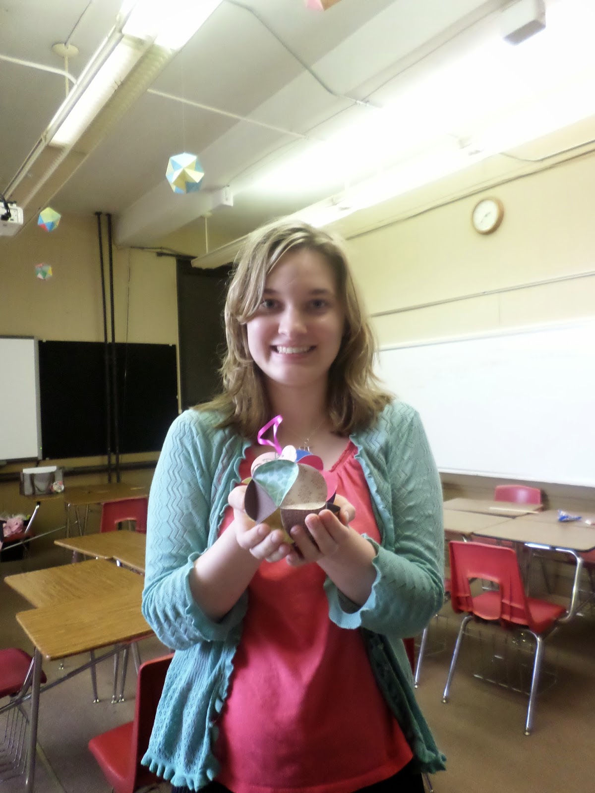 Sarah Carter holding icosahedron ornament ball. 