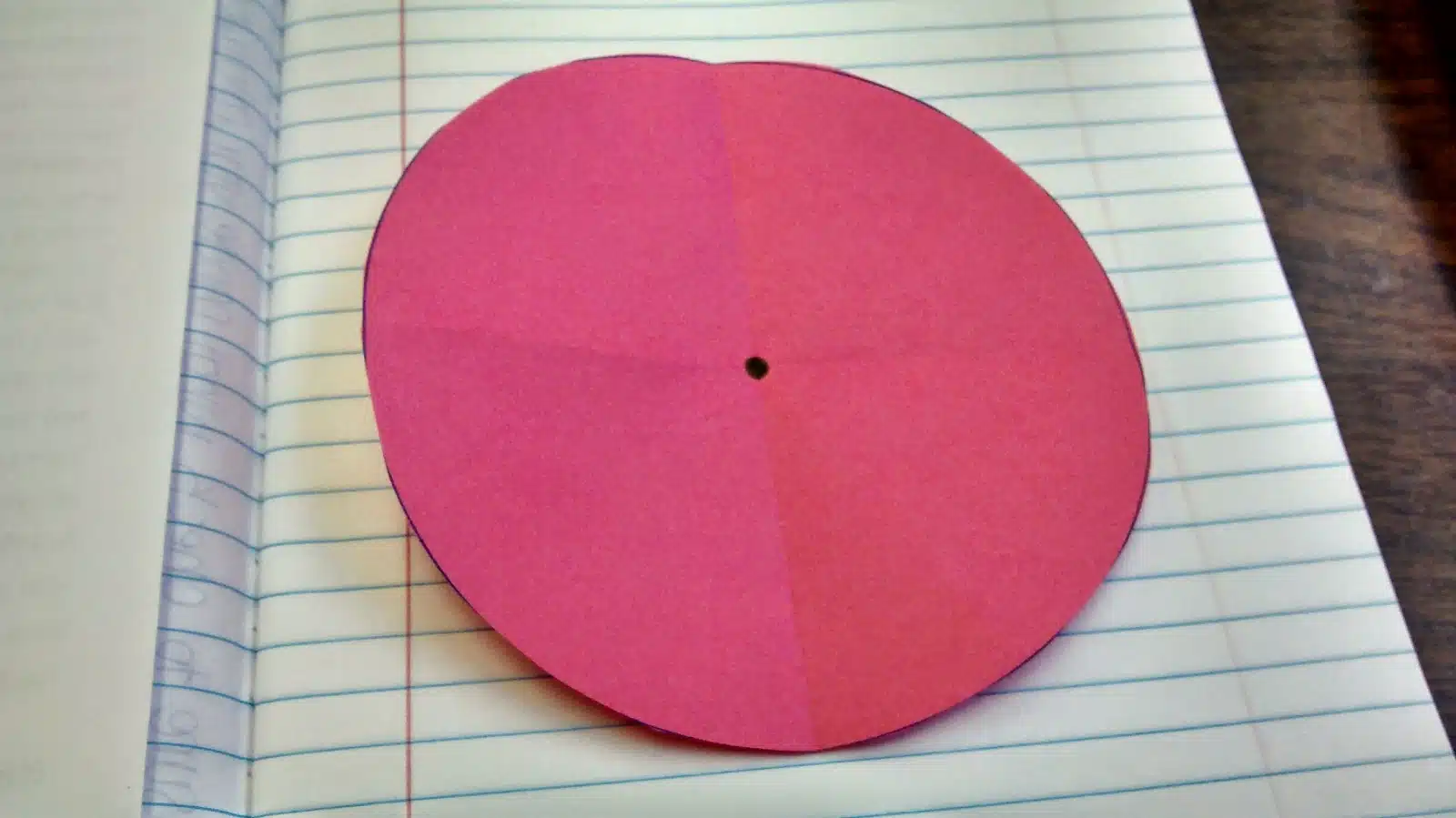 dot drawn in center of paper folded in fourths. 