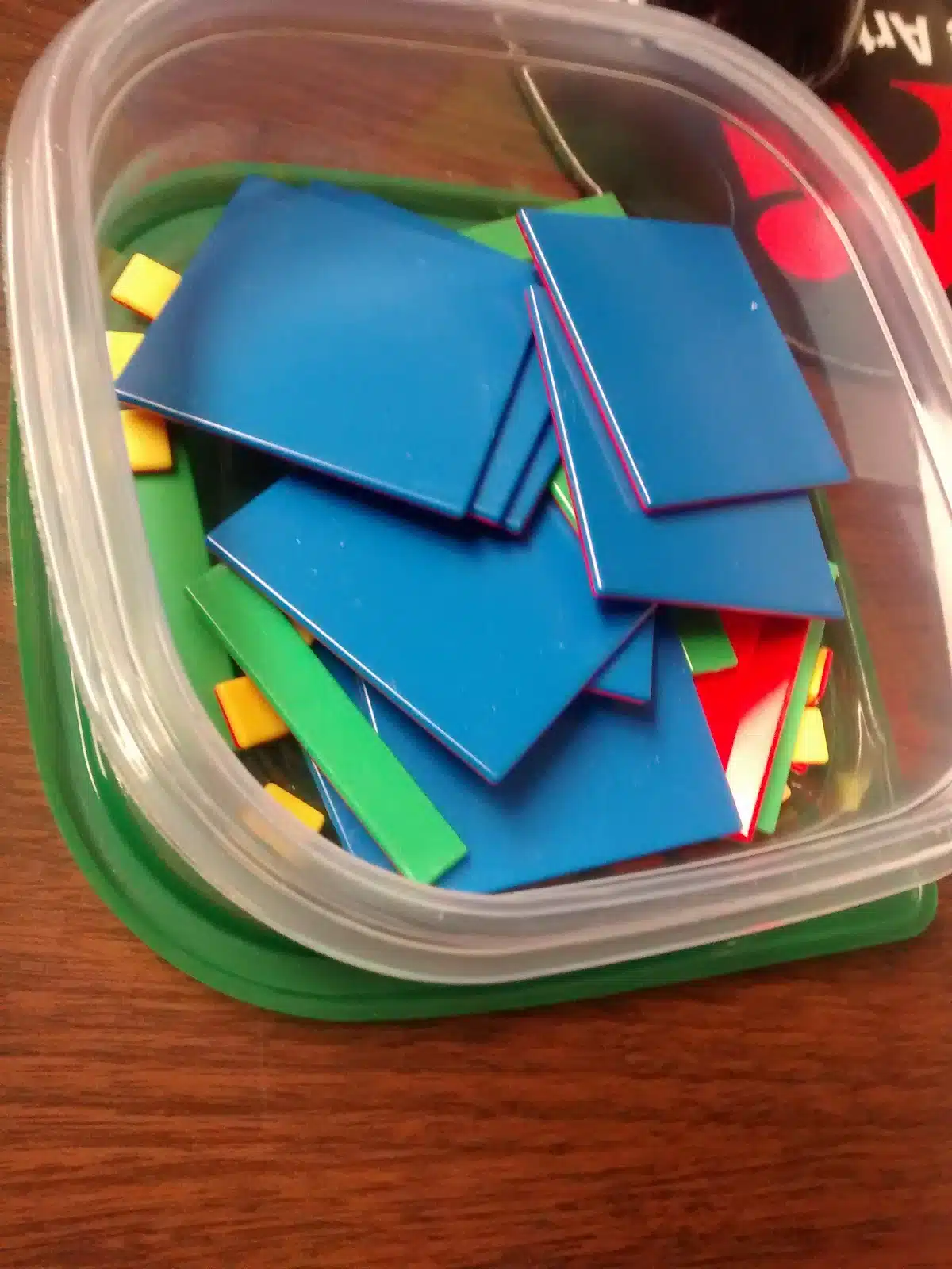 algebra tiles in square container. 