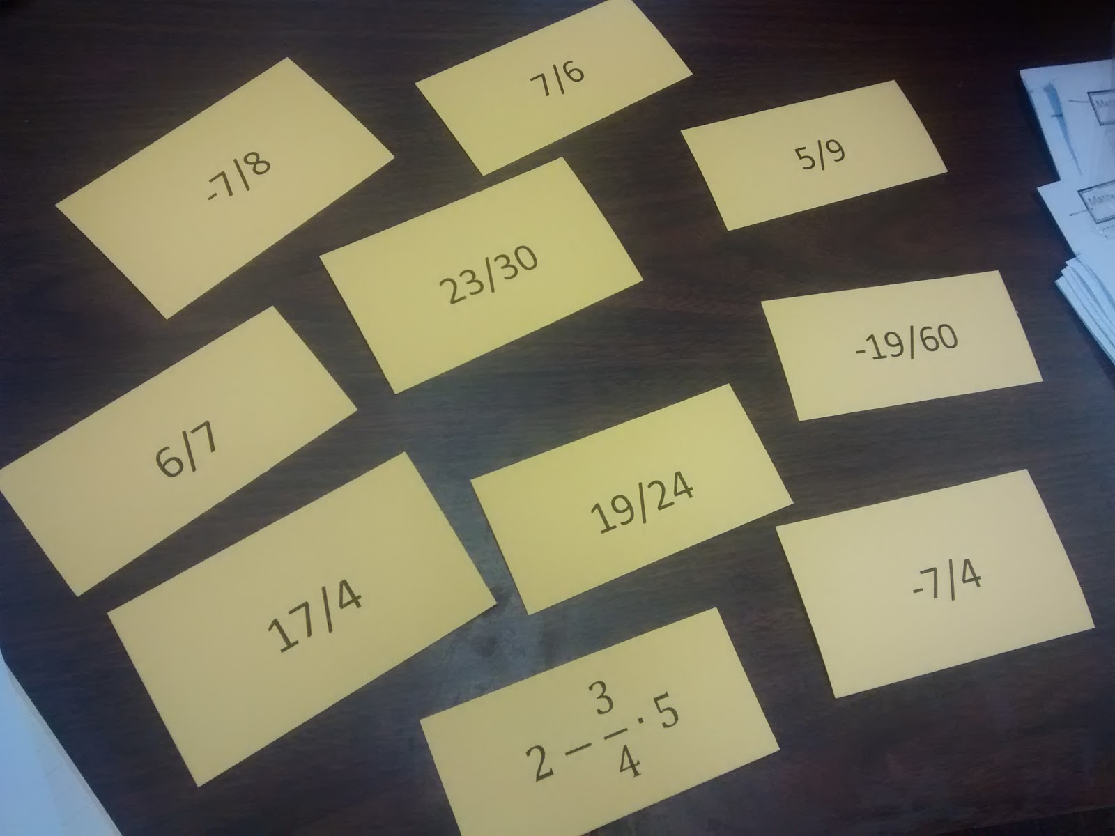 fraction operations question stack cards with fraction answers facing up. 