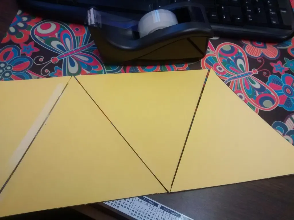 giant equilateral triangles taped together to form giant hexaflexagon. 