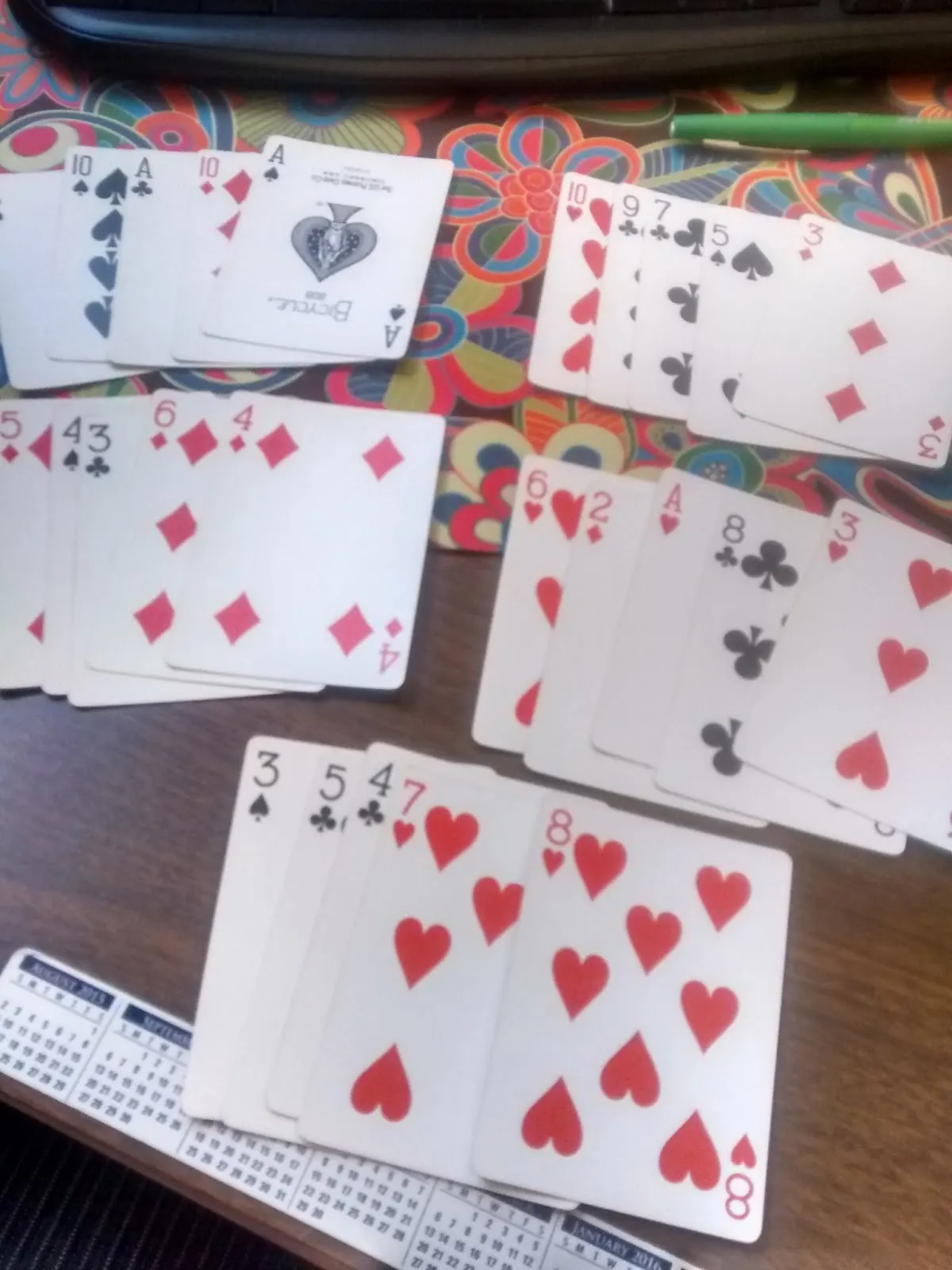 Cards laying on desk from playing 5 x 5 game from Sara Van Der Werf. 