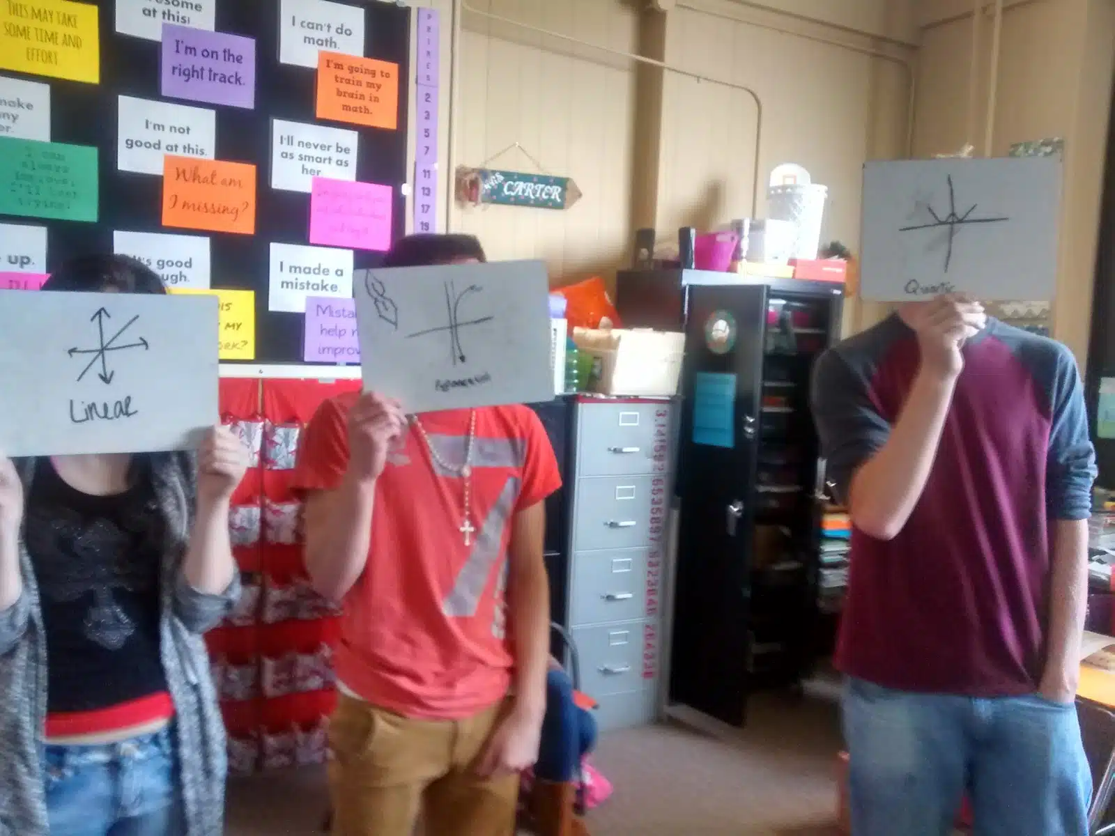 students holding up dry erase boards for two truths and a lie parent functions activity. 