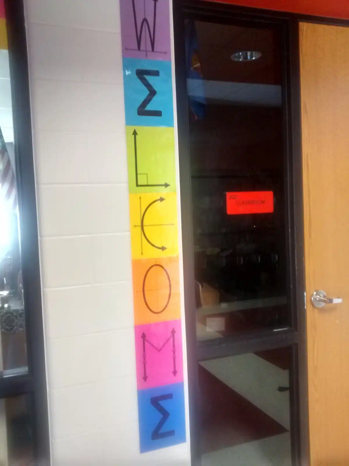 math welcome posters hanging vertically next to classroom door. 