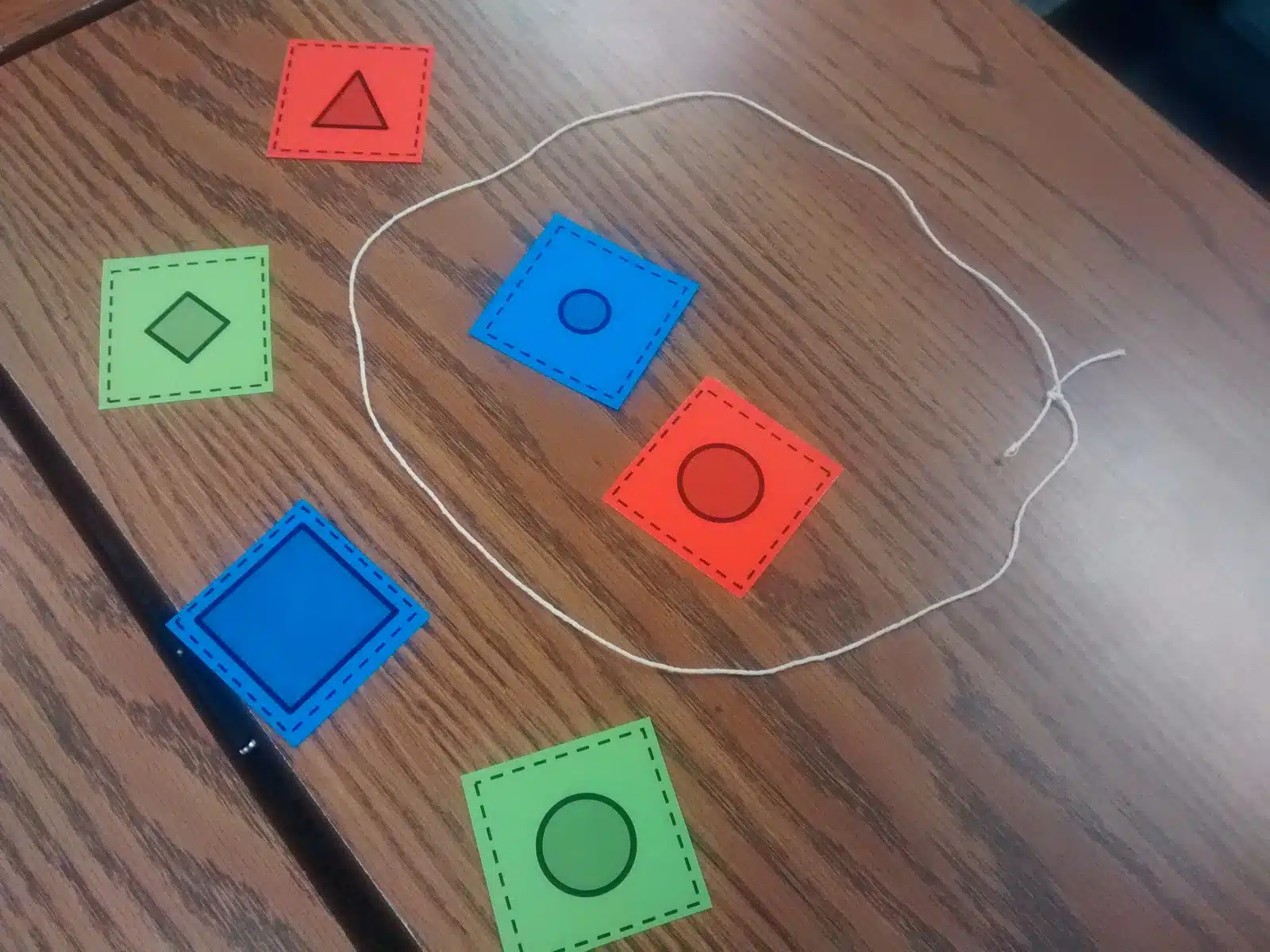 string with cards inside and outside of it for guess my rule activity. 