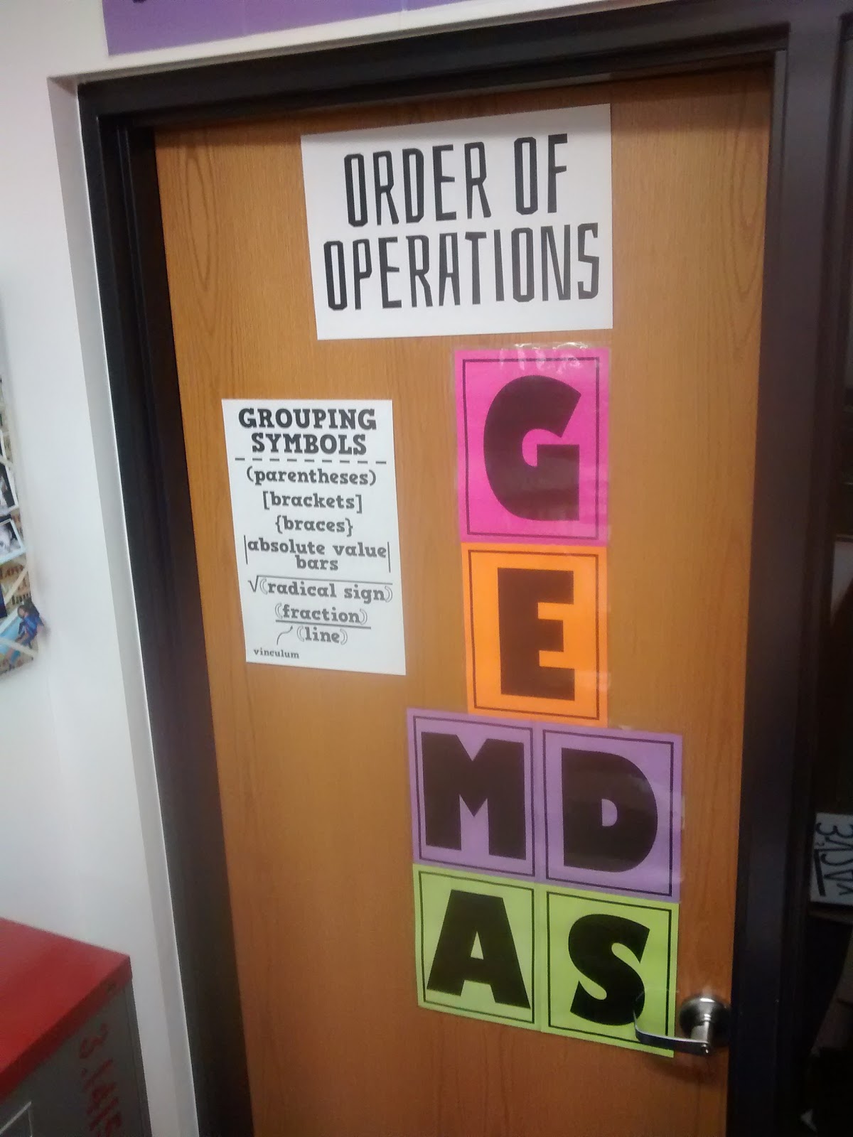 order of operations poster set on door of high school math classroom 