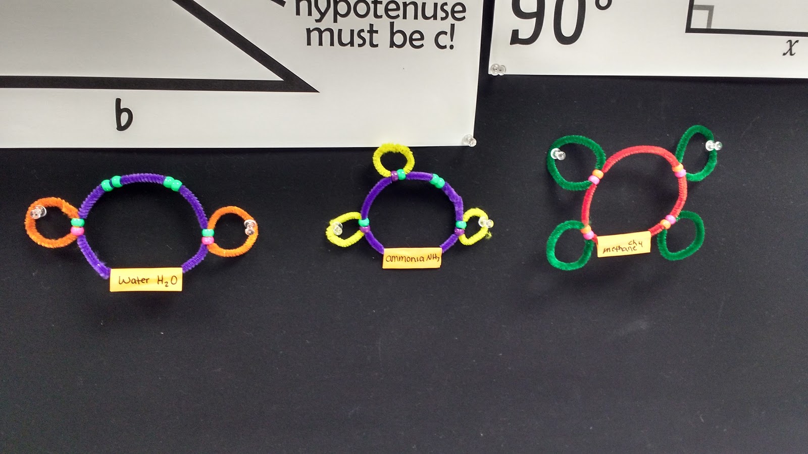 pipe cleaner covalent molecules hanging on bulletin board. 
