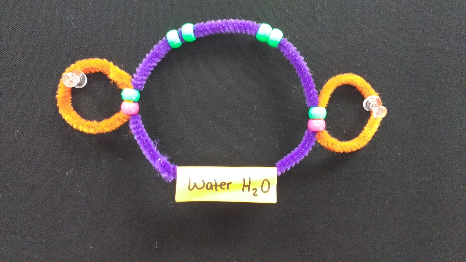 water molecule made with pipe cleaners and pony beads. 