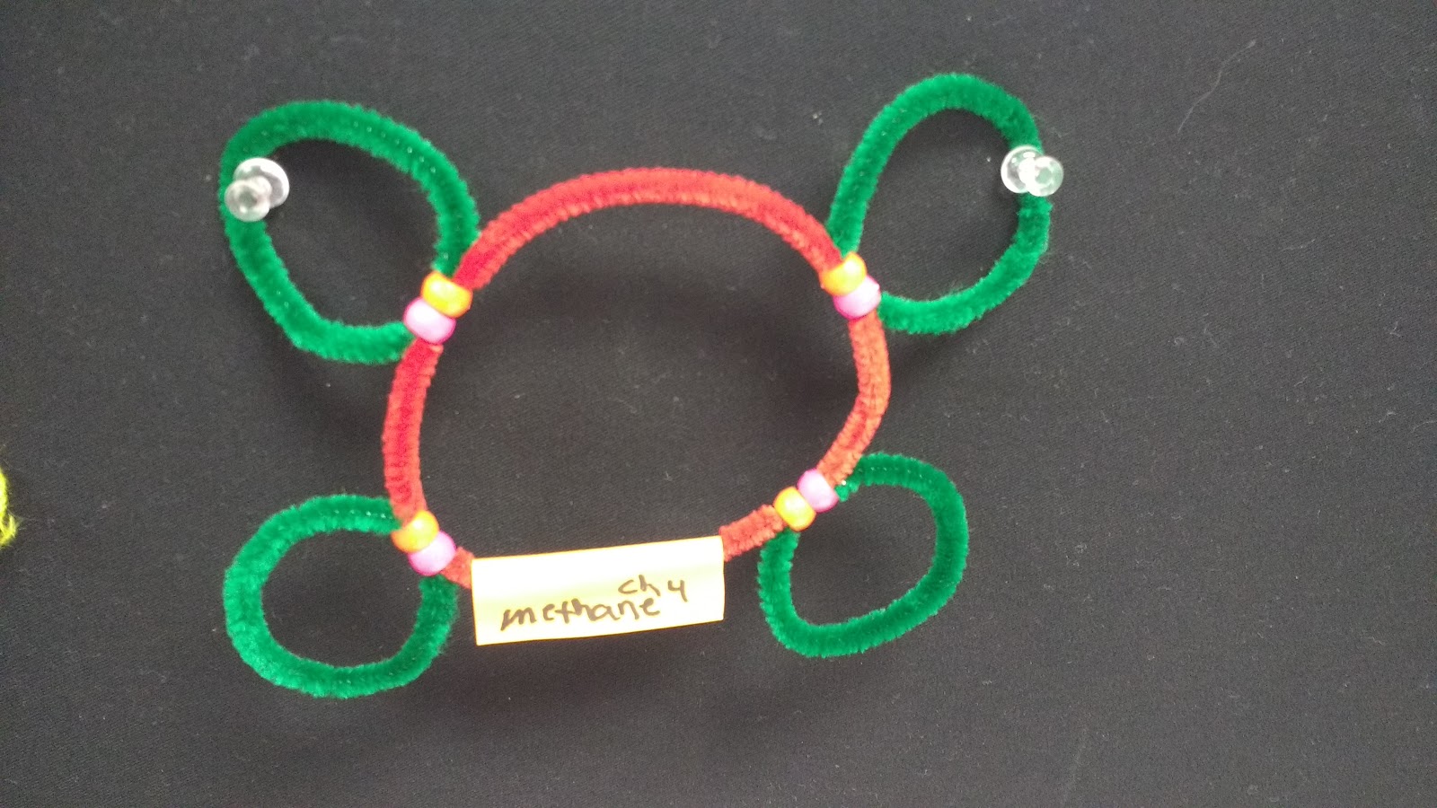 methane molecule made from pipe cleaners and pony beads. 