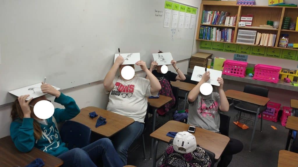 students playing drawing on your head christmas game. 