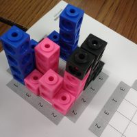linking cubes on skyscraper puzzle board.
