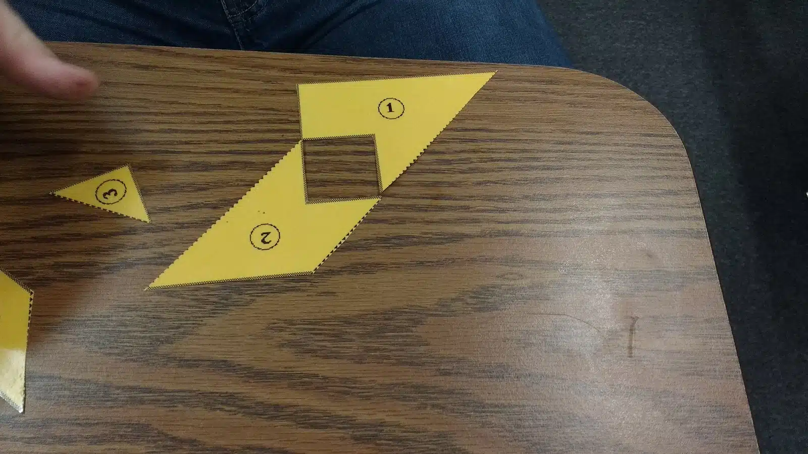 Student's Silly Attempt at forming a square with the square pi puzzle pieces. 