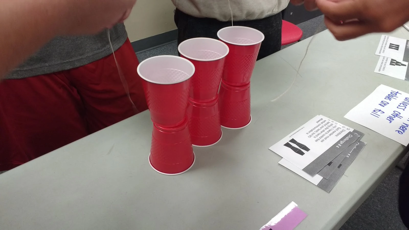 high school students participating in cup stacking challenge as a team building activity during the first week of school 