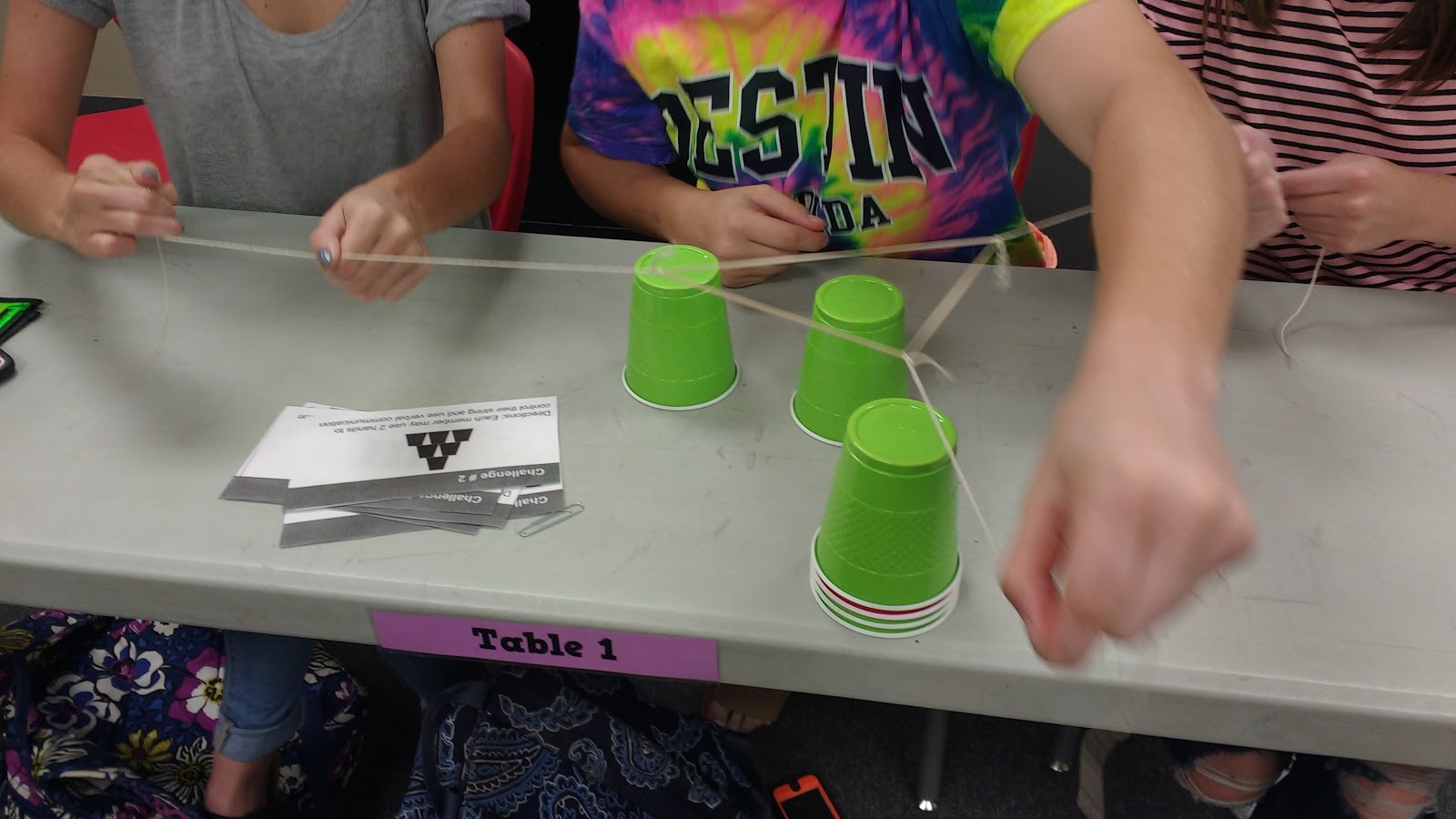 high school students participating in cup stacking challenge as a team building activity during the first week of school 
