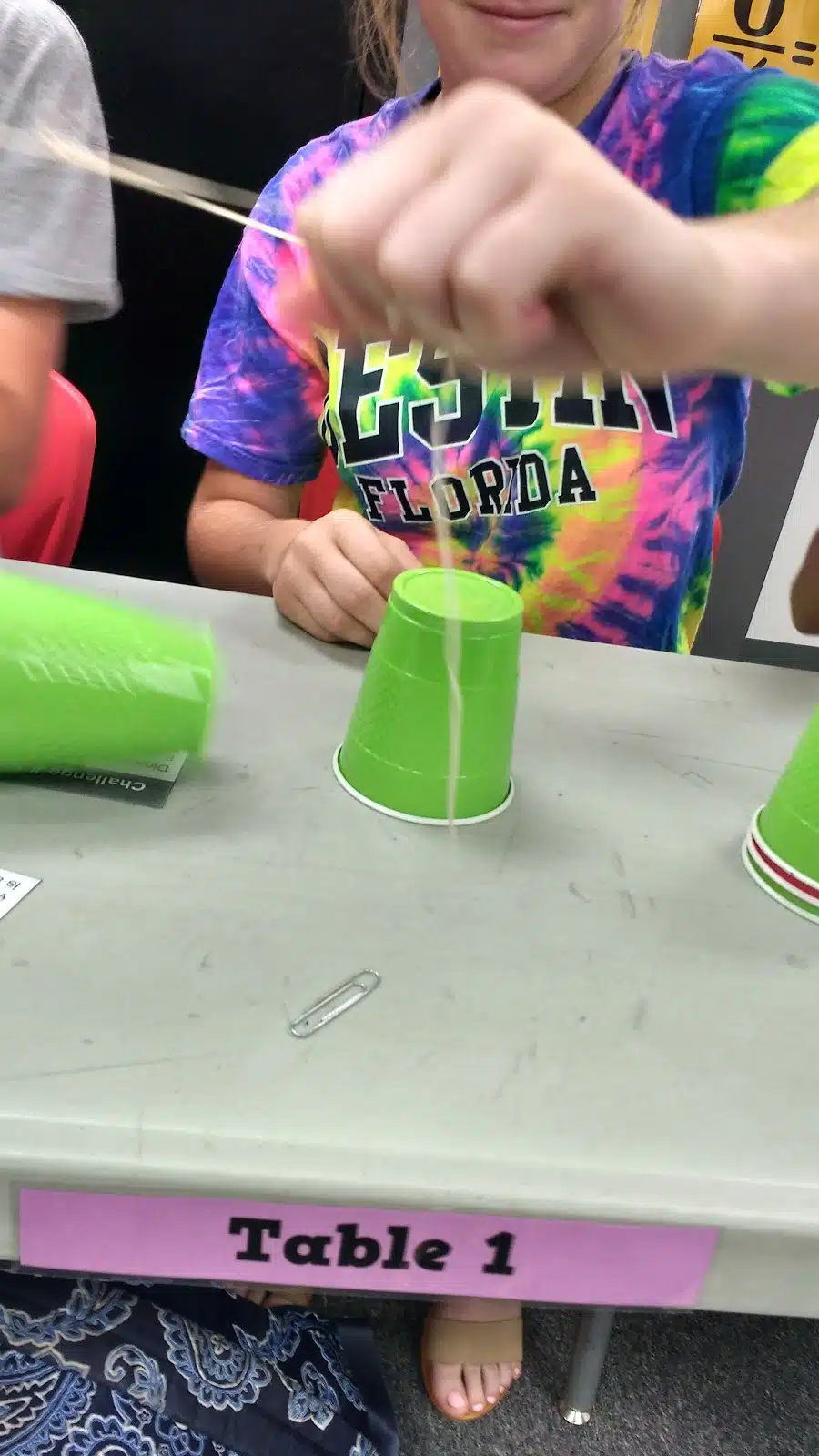 high school students participating in cup stacking challenge as a team building activity during the first week of school 