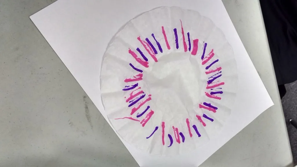 pink and purple design drawn on coffee filter. 