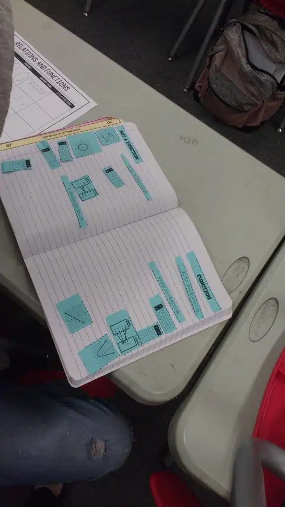 students working on Function vs Not a Function Card Sort Activity in algebra 1 interactive notebook. 