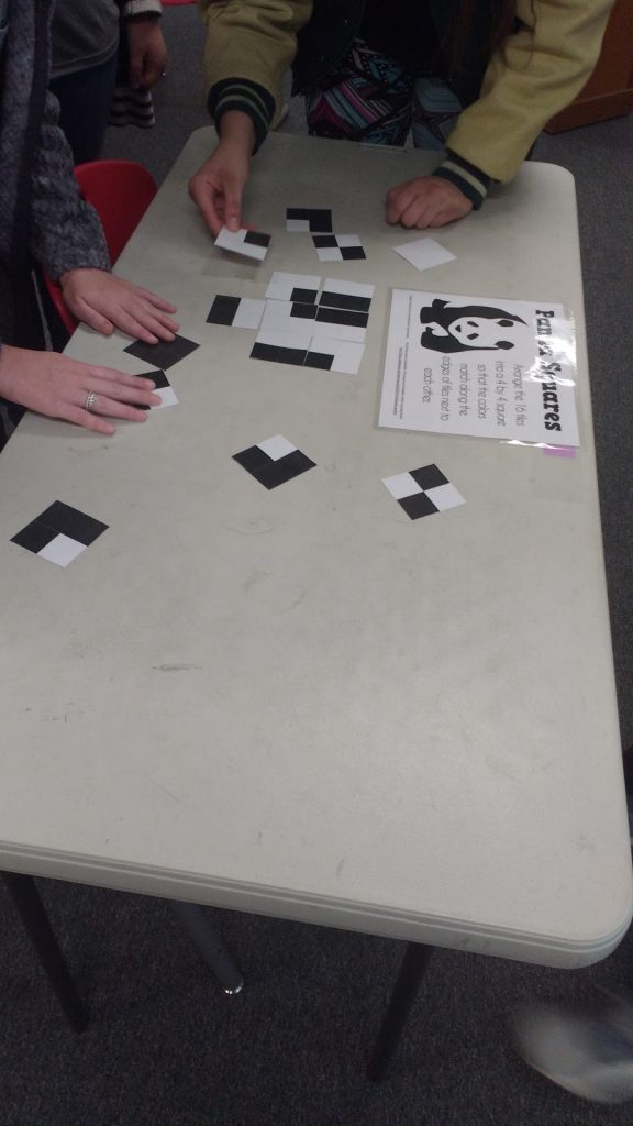 Students working to solve panda squares puzzle 