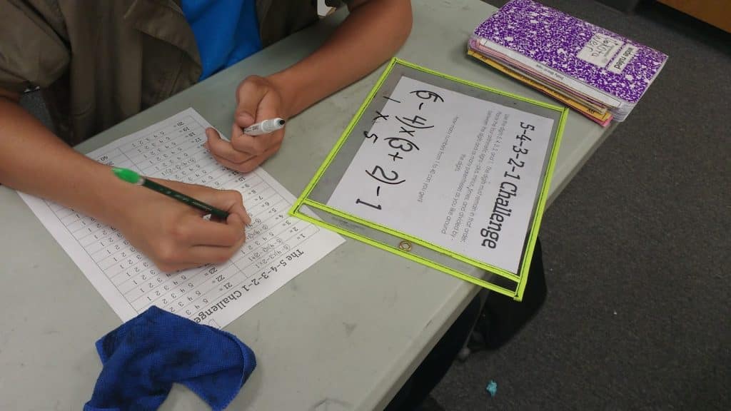 student working on 5-4-3-2-1 challenge puzzle. 