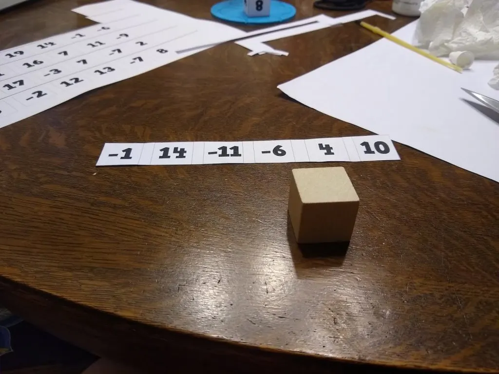 Blank wooden cube with strip of numbers to create genius blocks. 