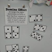 Domino Effect Puzzle on Dry Erase Board in Classroom.