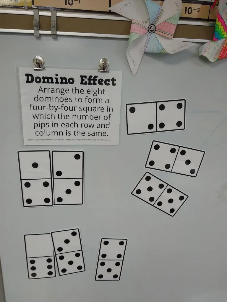 Domino Effect Puzzle on Dry Erase Board. 