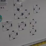 Four Aces Puzzle on Dry Erase Board.