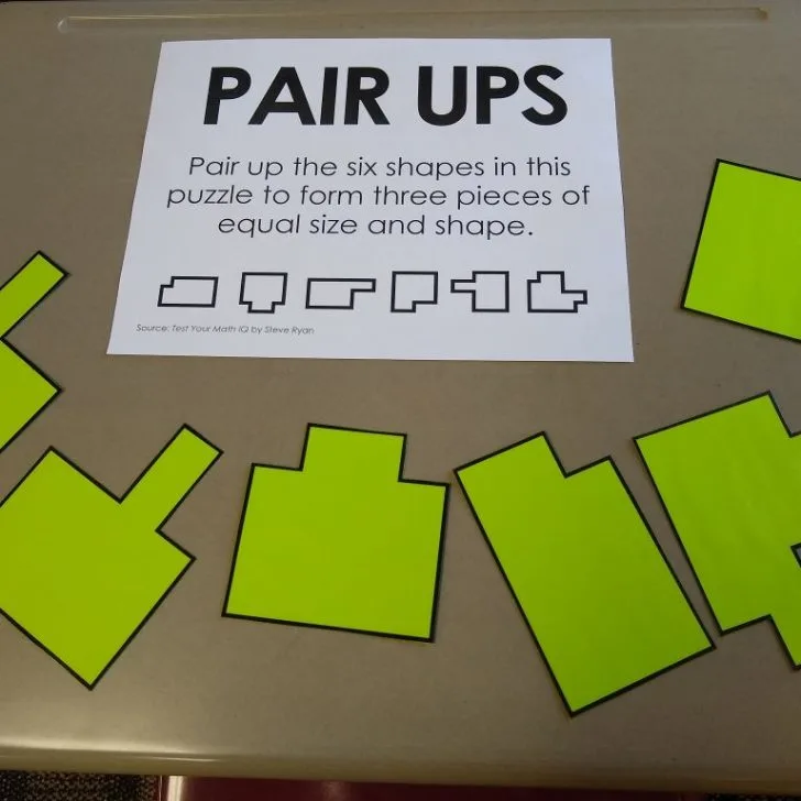 pair ups puzzle laying on desk in classroom.