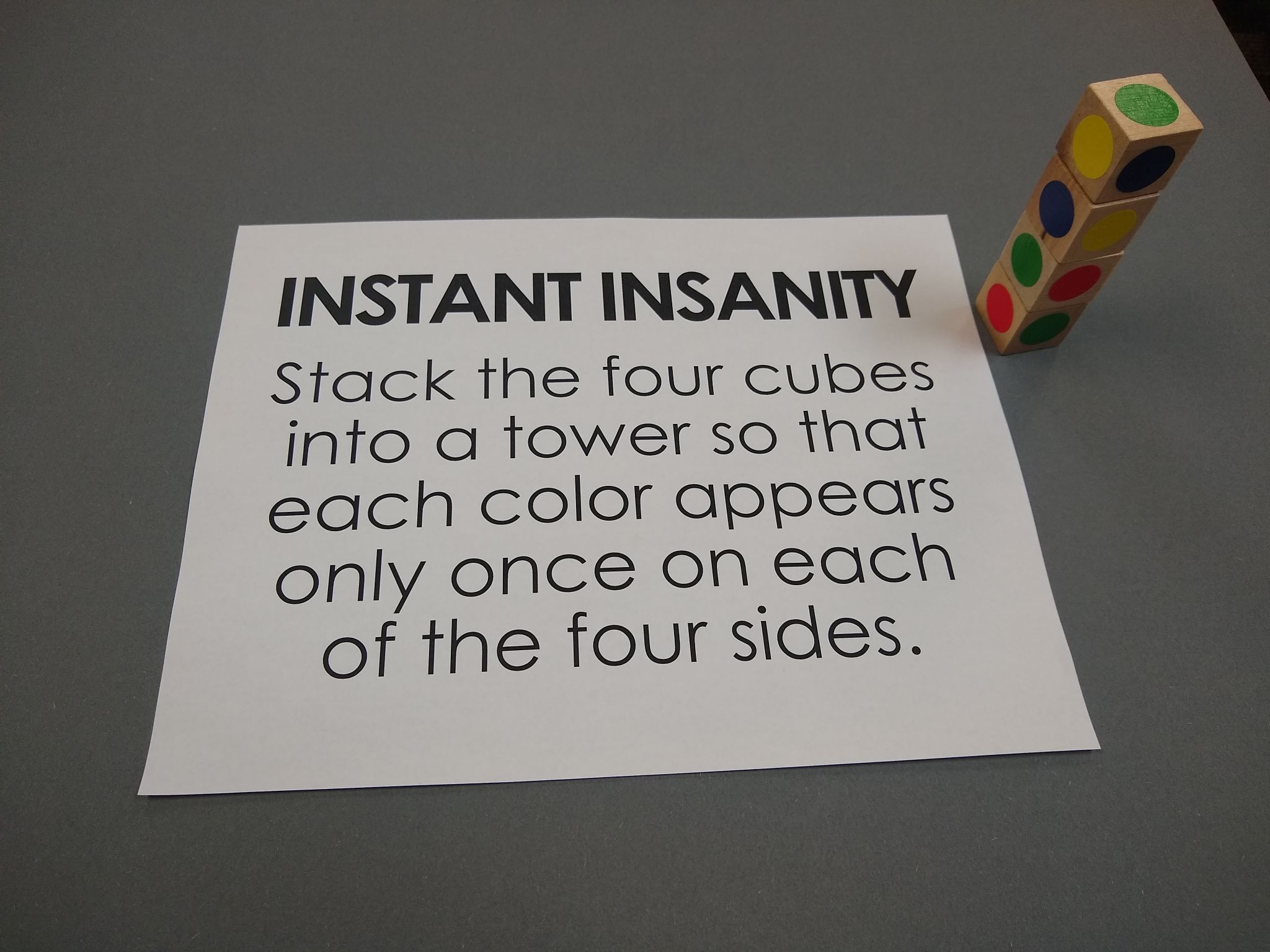 diy instant insanity puzzle with wooden cubes. 
