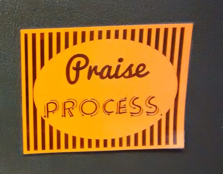 praise process poster printed on orange paper.