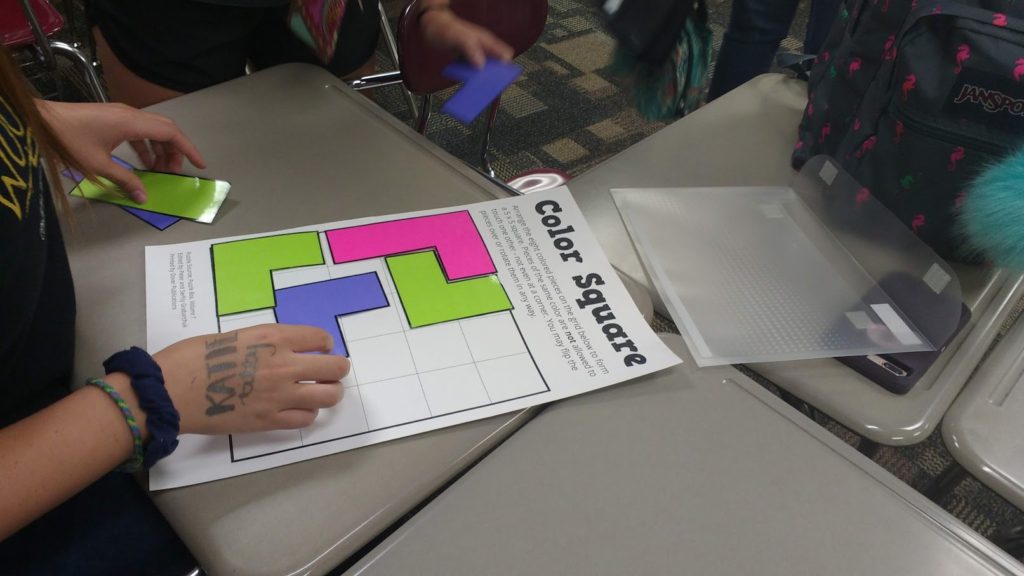 Student Working to Solve Color Square Puzzle 