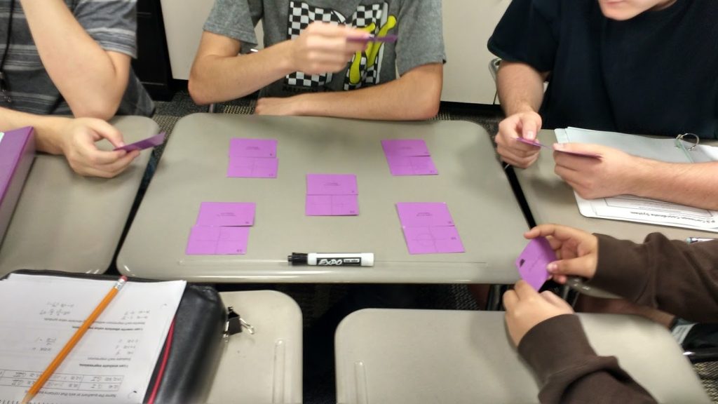 students working on conic cards activity. 