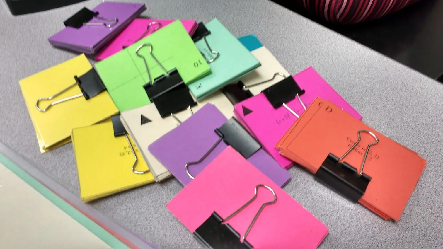 conic card piles held together by binder clips. 