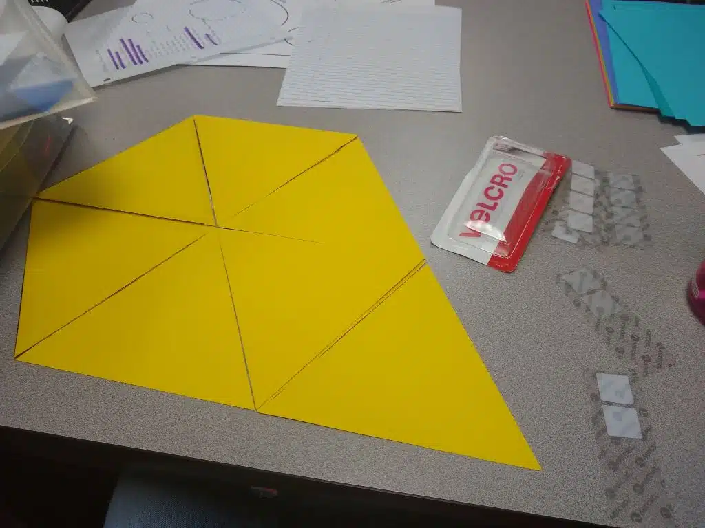 giant equilateral triangles taped together to form giant hexaflexagon. 