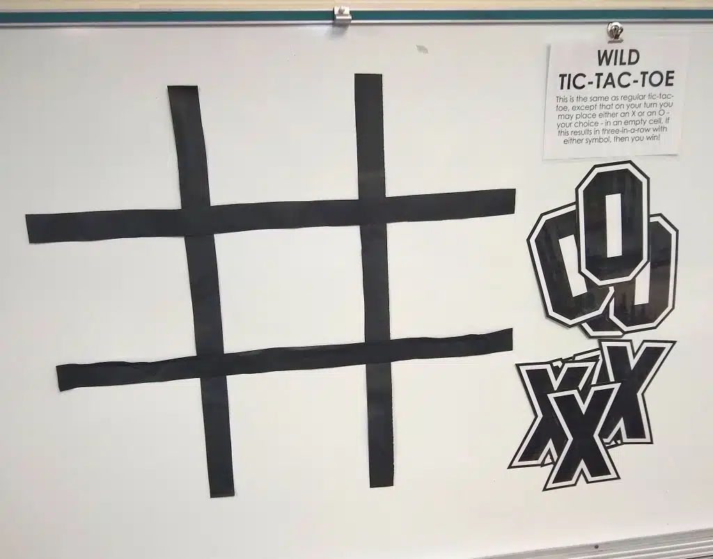 jumbo version of wild tic tac toe game on dry erase board in math classroom. 