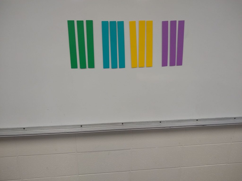paper strips with magnets on them for let's make squares activity. 