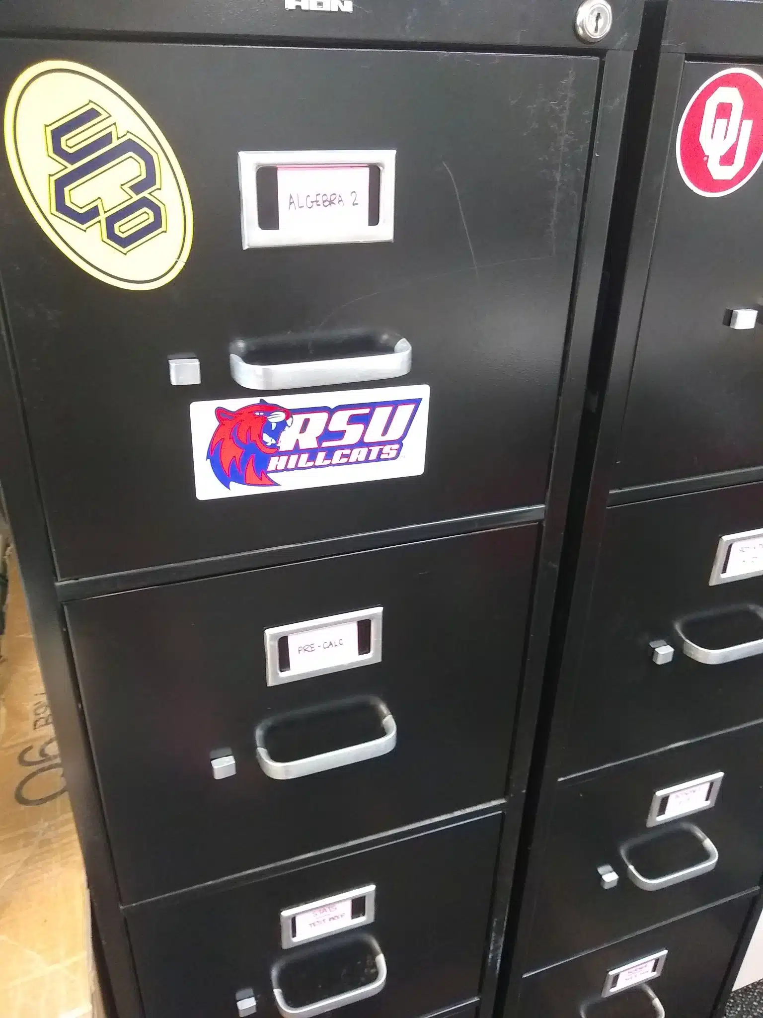 Close-Up of Black Filing Cabinet in High School Math Classroom. 