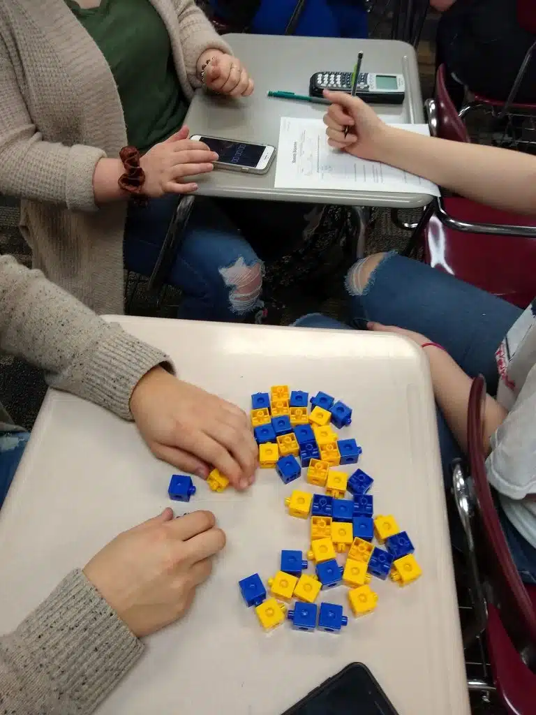 Students working with linking cubes for speedy squares activity. 