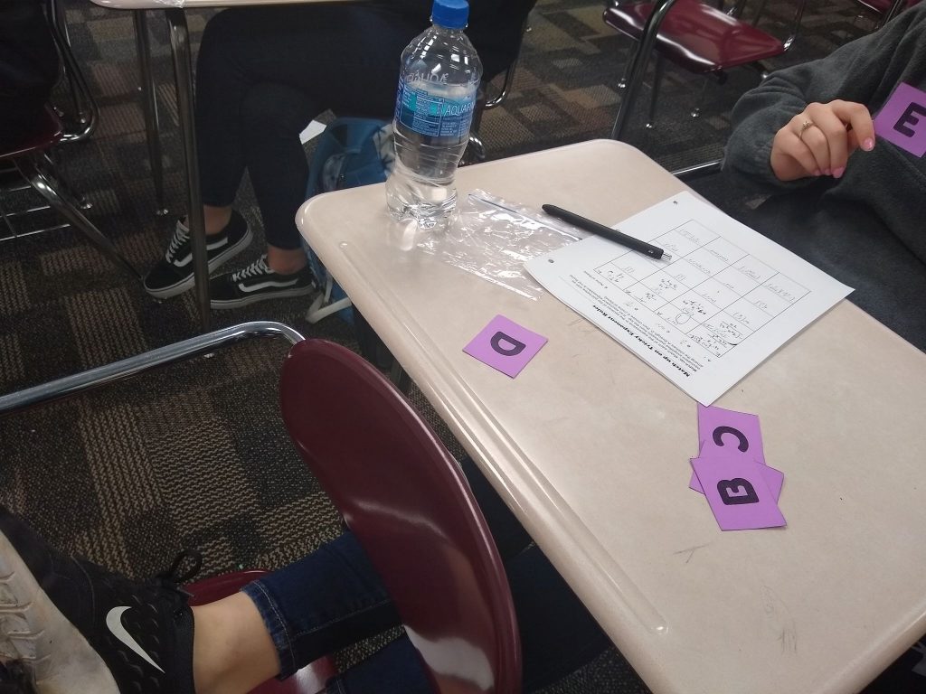 student holding up card for Exponent Rules Match-Up Activity