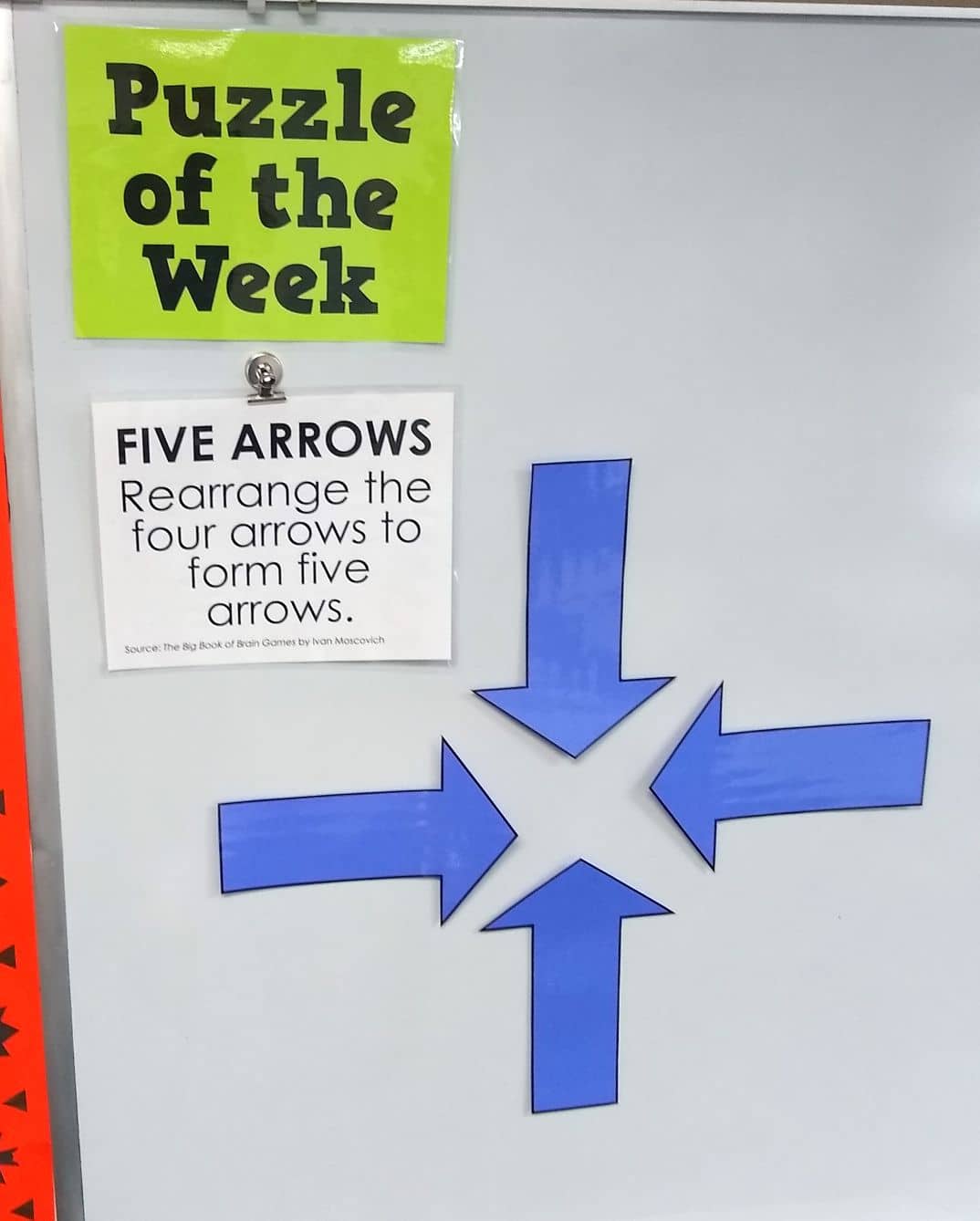 Five Arrows Puzzle Hanging on Dry Erase Board. 