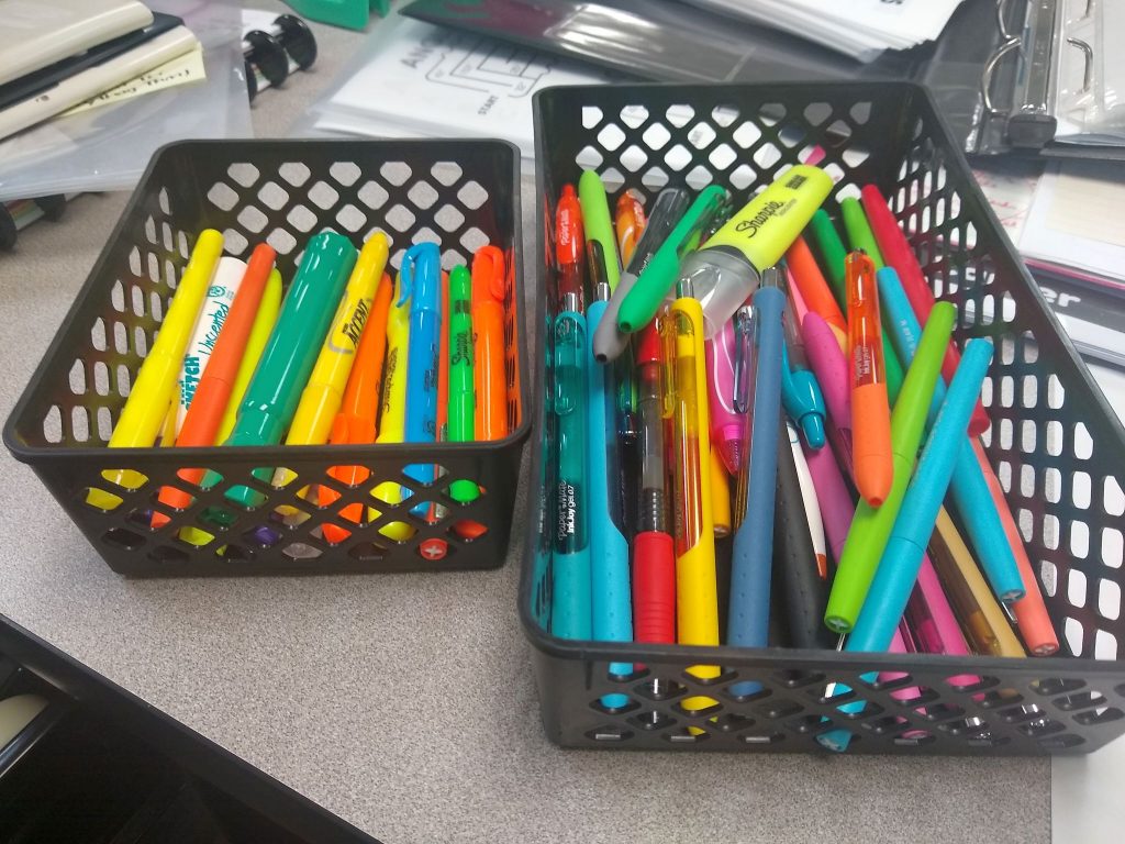 baskets of colored ink pens and highlighters 